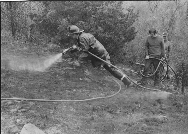 From the Archives: Grass Fire in Indian Hills.  From The Westerly Sun 4/29/74.  Caption reads: &quot;Firemen from the Dunn's Corners Department attacking a brush and grass fire that burned about 1/2 acre at the east edge of Indian Hills at Dunn's Corners early yesterday afternoon.  Chief Henry M. Morris said the fire was apparently started by someone smoking or playing with matches.  A packet of discared matches was found in the fire area, he said.  Firemen responed to the alarm in three trucks and halted the flames in twenty minutes.&quot;